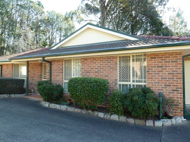 Home (no steps) in quiet area next to a reserve.