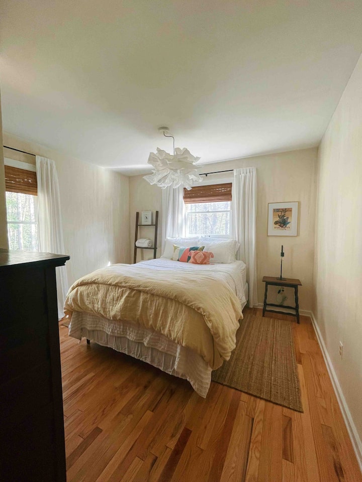 The downstairs guest room features a plush queen bed