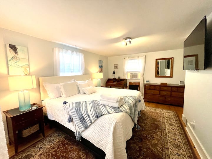 Master bedroom with a king-size Enso mattress, Roku TV, and separate entrance.