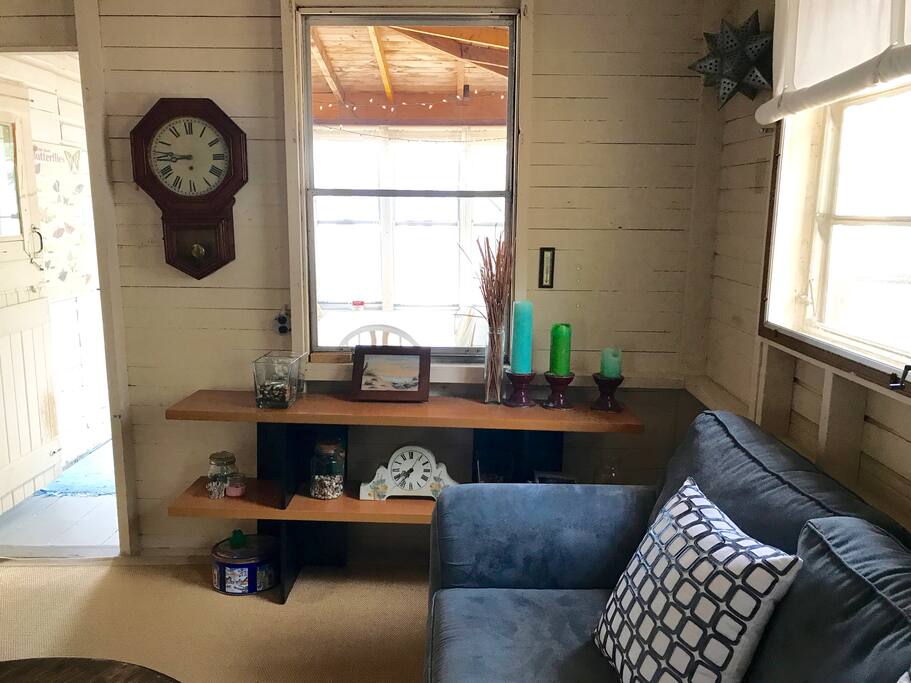 Main living room area. One large couch and 2 lounge chairs.