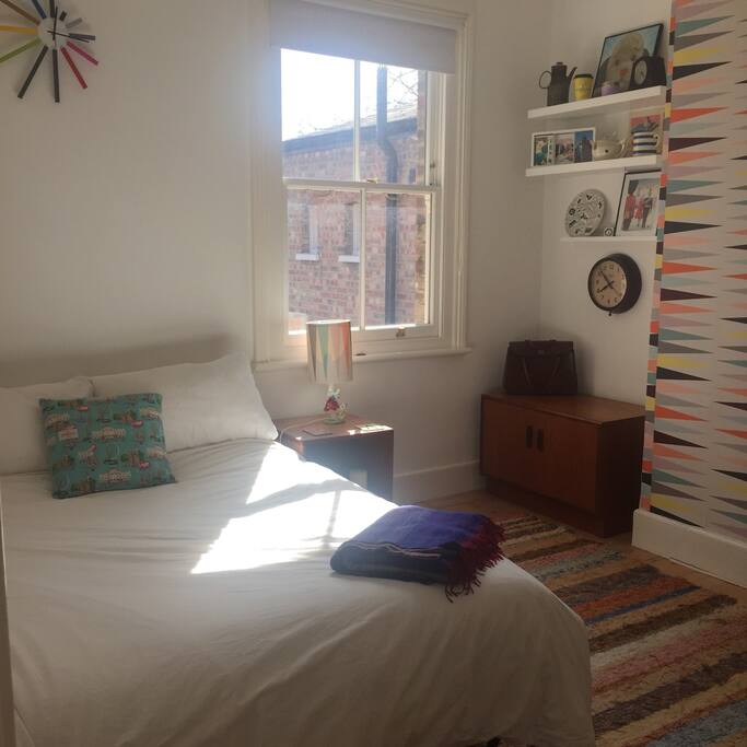 Roomy double bedroom with funky mid-century theme