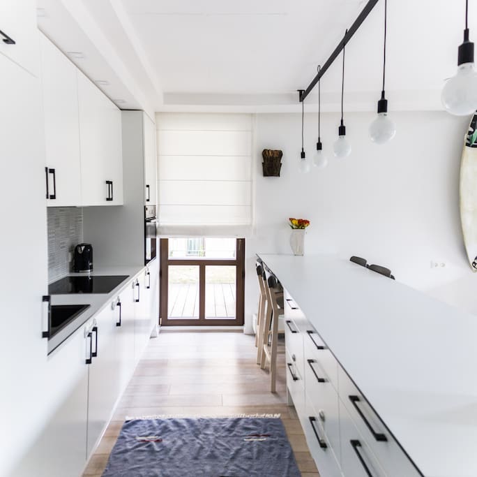 Spacious kitchen together with the door to the big private terrace.