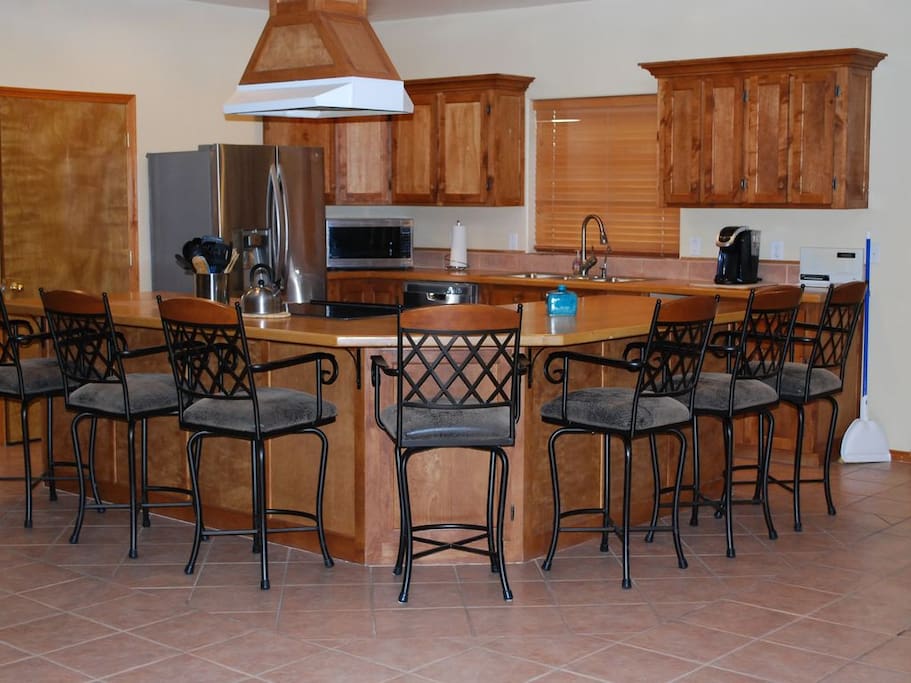 Kitchen bar comfortably seats 8