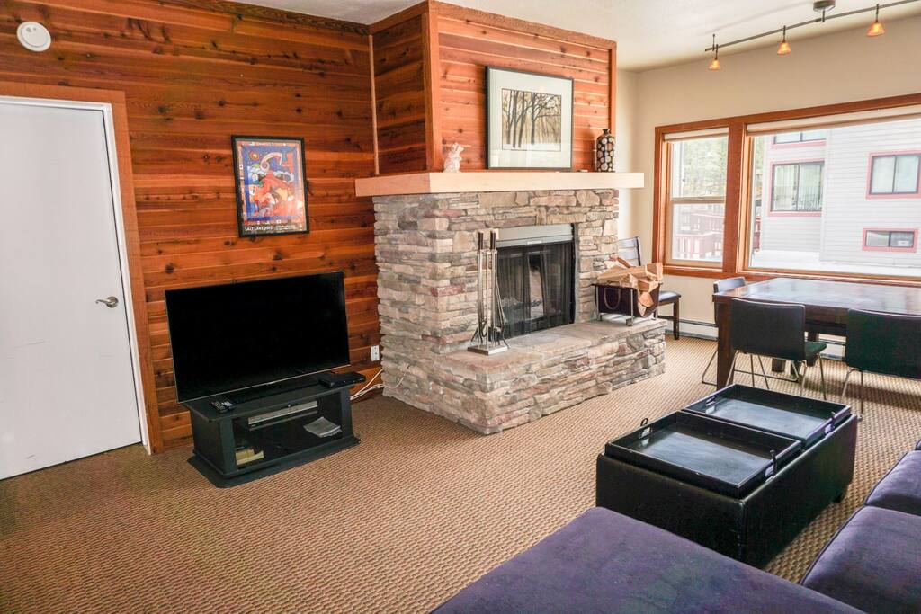 Couch facing TV and fireplace