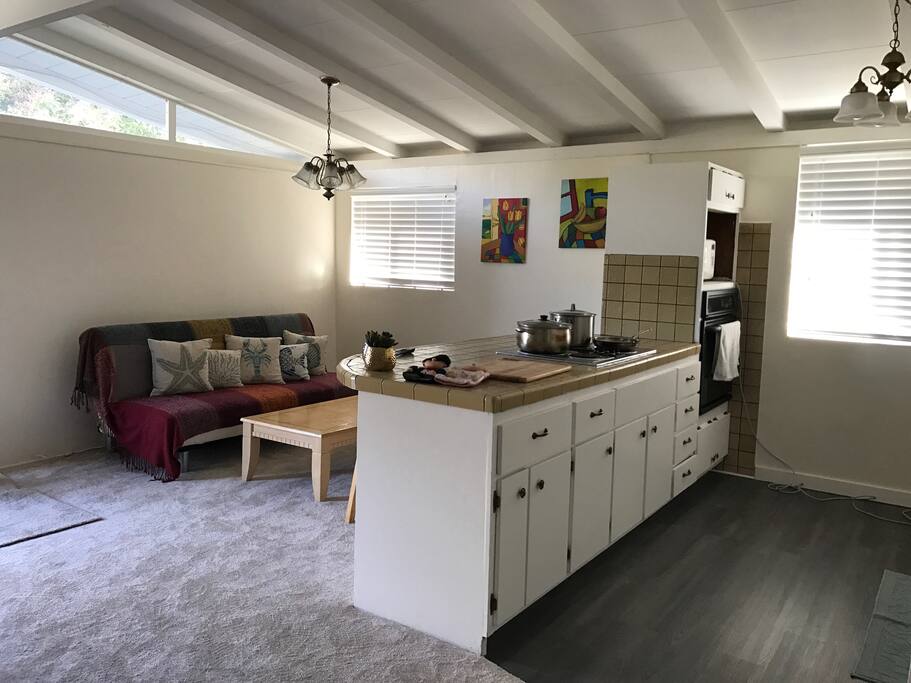 Living room corner and kitchen island. The sofa in the living room can be converted to a full size bed if you have a friend that want to crack the house. However, extra service fee will be collected in a nightly basis and must obtain host approval in advance. No extra keys will be provided.