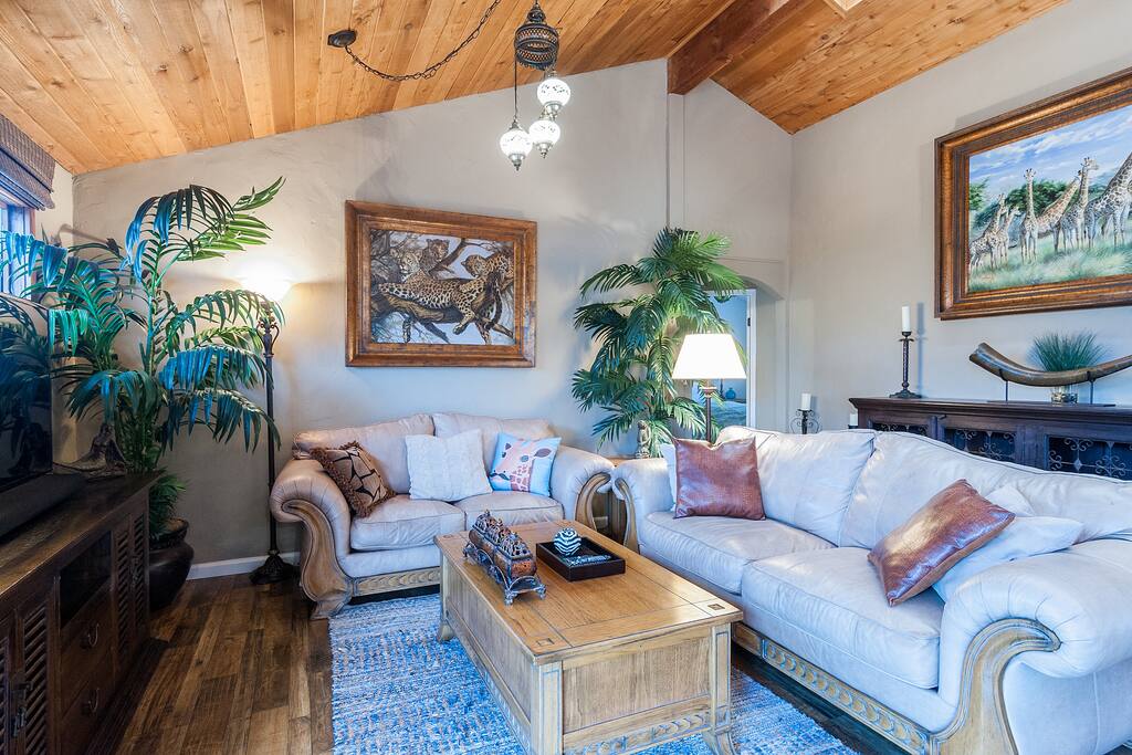 Living Area of the Great Room with skylights, leather couches, new flatscreen TV and sound bar