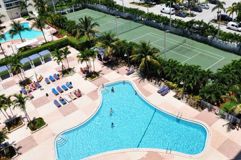 View of the magnificent tennis courts and the condo's outdoor heated pools
