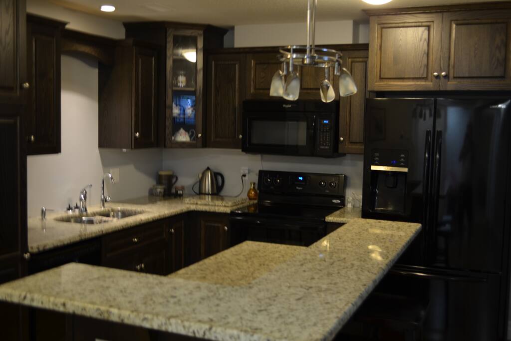 Granite counters and pot lights throughout this kitchen space.