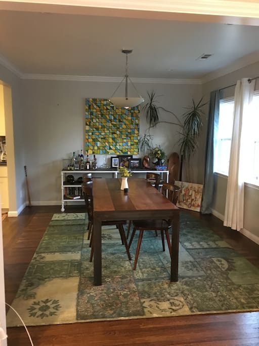 Dining room. Curtains open. Kitchen to the left.