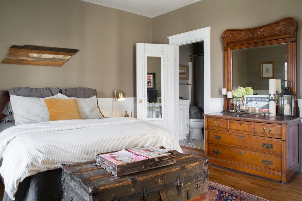 Antique and vintage rugs + furnishings accent the space. We've got an iron/ironing board for your use as well!