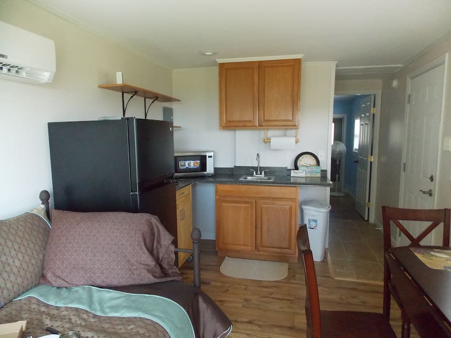 This is the kitchen with everything you need to cook and the furnishings to cook and eat with!
