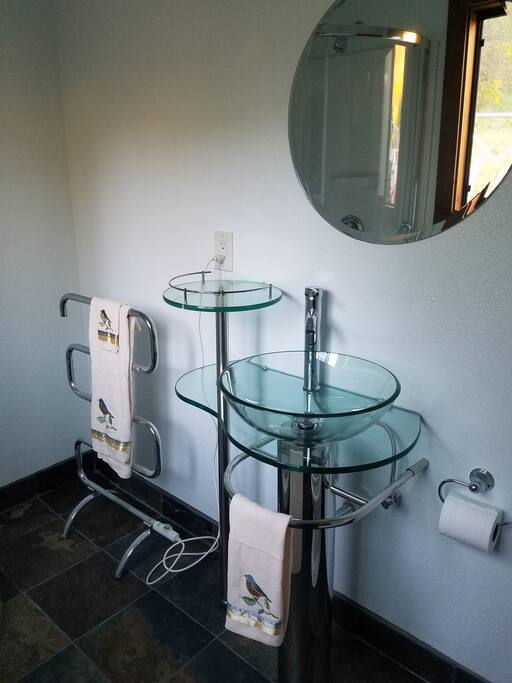 Newly finished bathroom with heated towel rack.