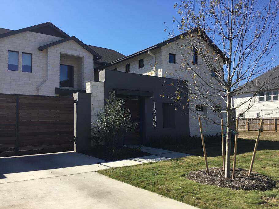 New modern home with controlled access entry and multi security camera coverage.
