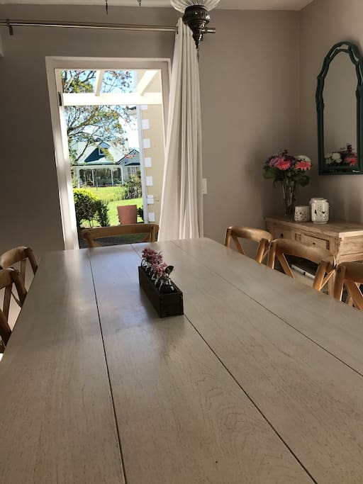 Open plan lounge, kitchen and dining area, leading to outside with a small garden and lovely common pond area