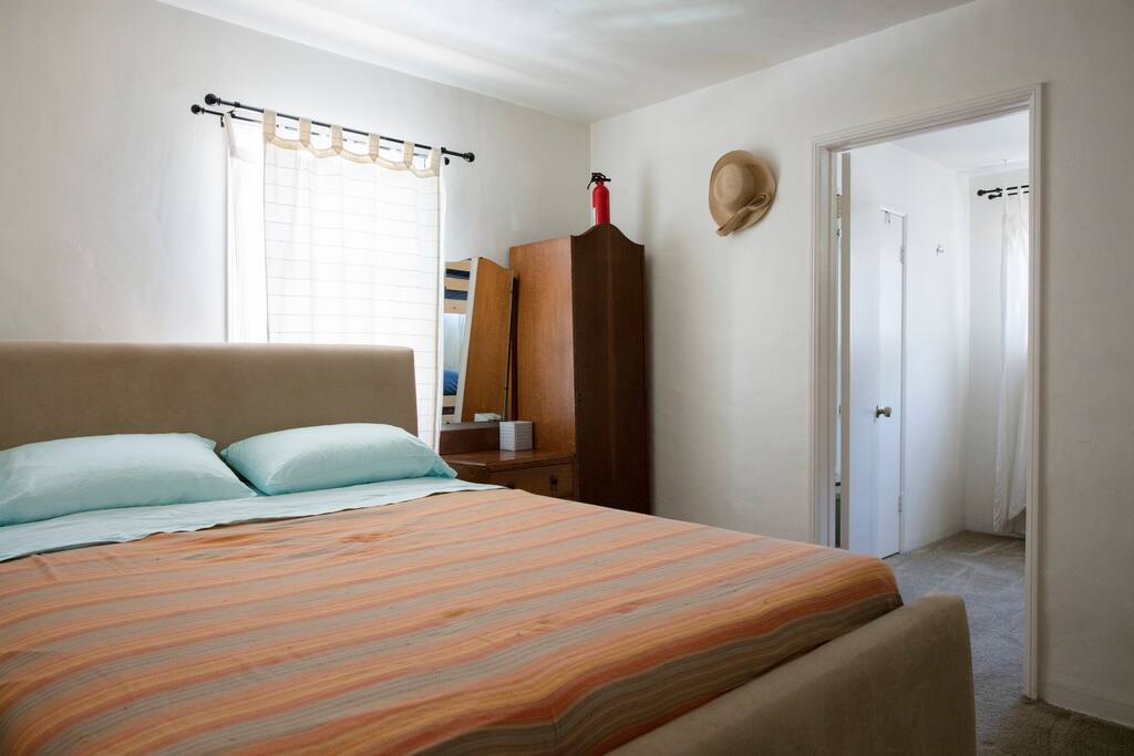 Master bedroom wardrobe armoire can be used for storage of small luggage.