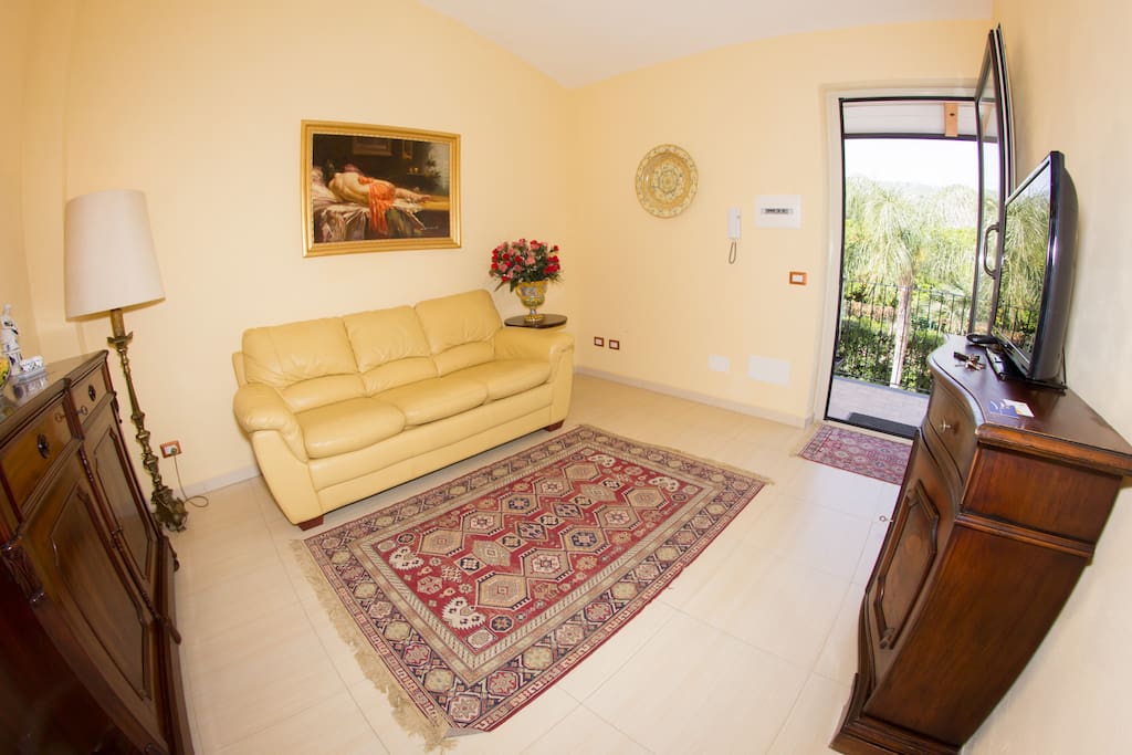 Living room with Sat TV and double sofa bed - Suite Apt Lorena - AGRITURISMO ROSEMARINE - SUNTRIPSICILY COM