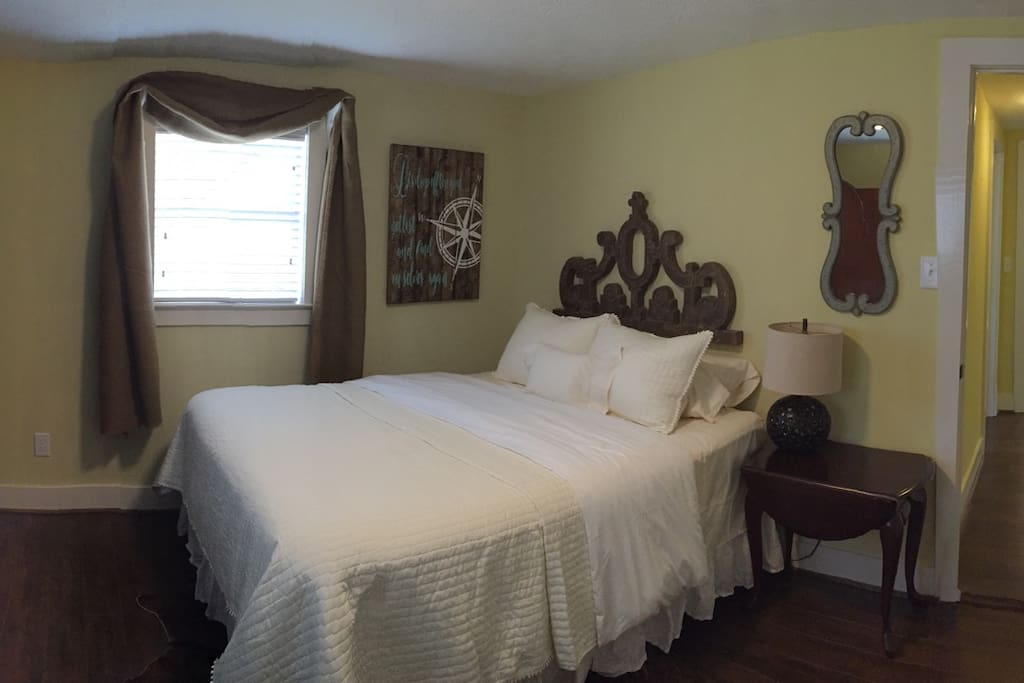 Main bedroom with queen bed and plush bedding.