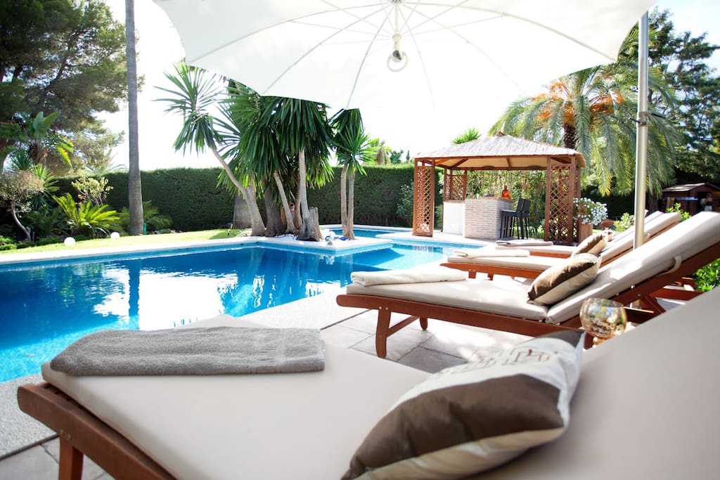 An inviting pool with enough beds for all.