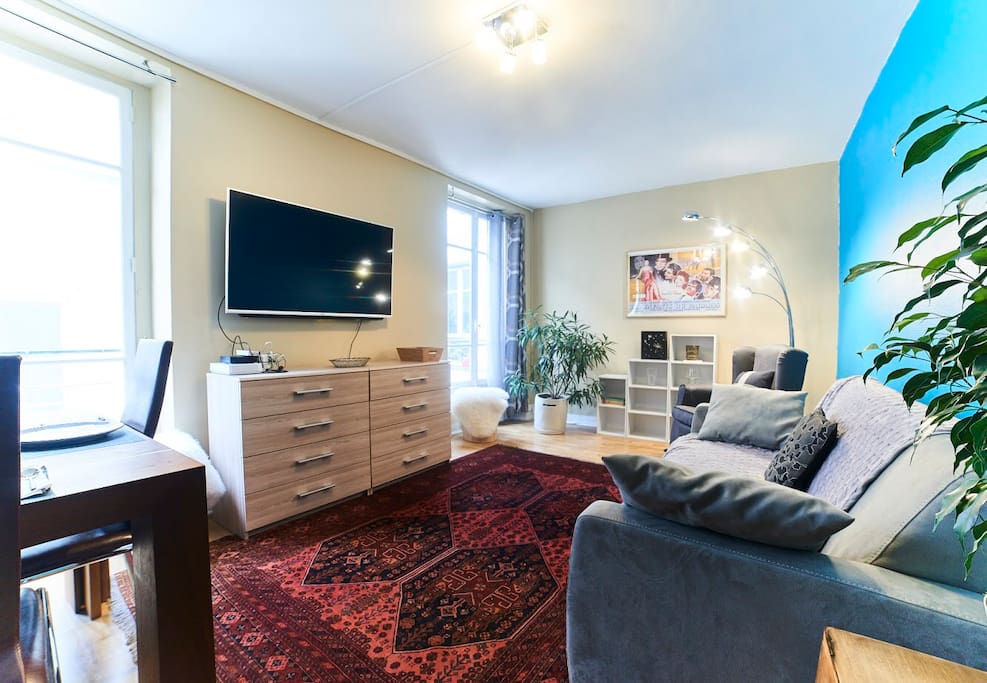 Cozy living room featuring our favorite carpet (that really ties the room together), a giant 55-inch LED Internet-ready large screen t.v. and super-comfy queen-sized Simmons sofa bed.