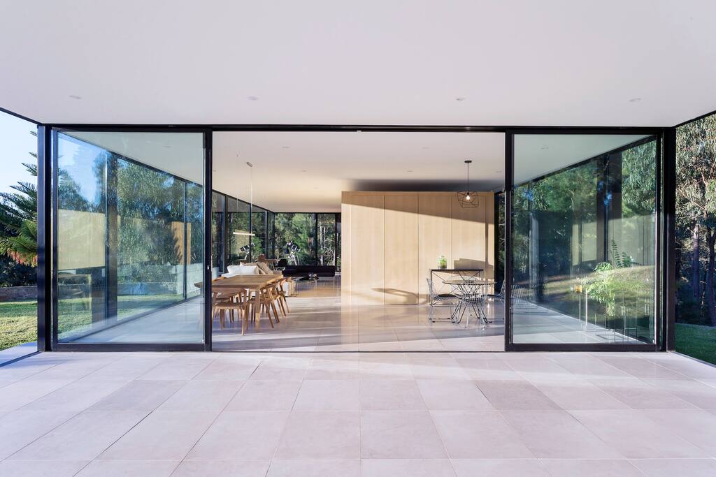 The entrance features 2 huge sliding doors to bring the outside, inside.