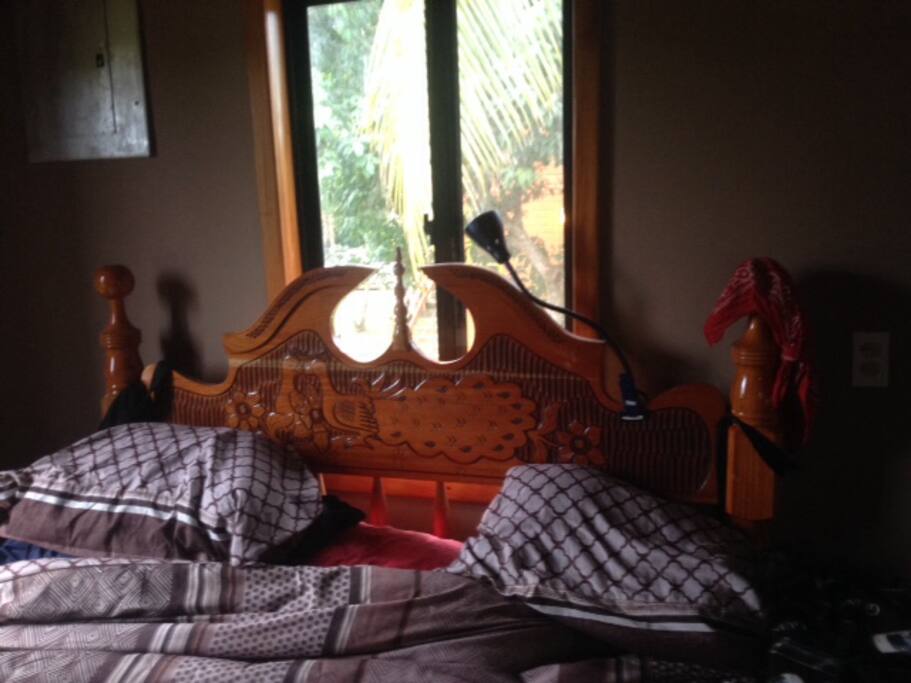 Hand carved new headboard on new queen bed