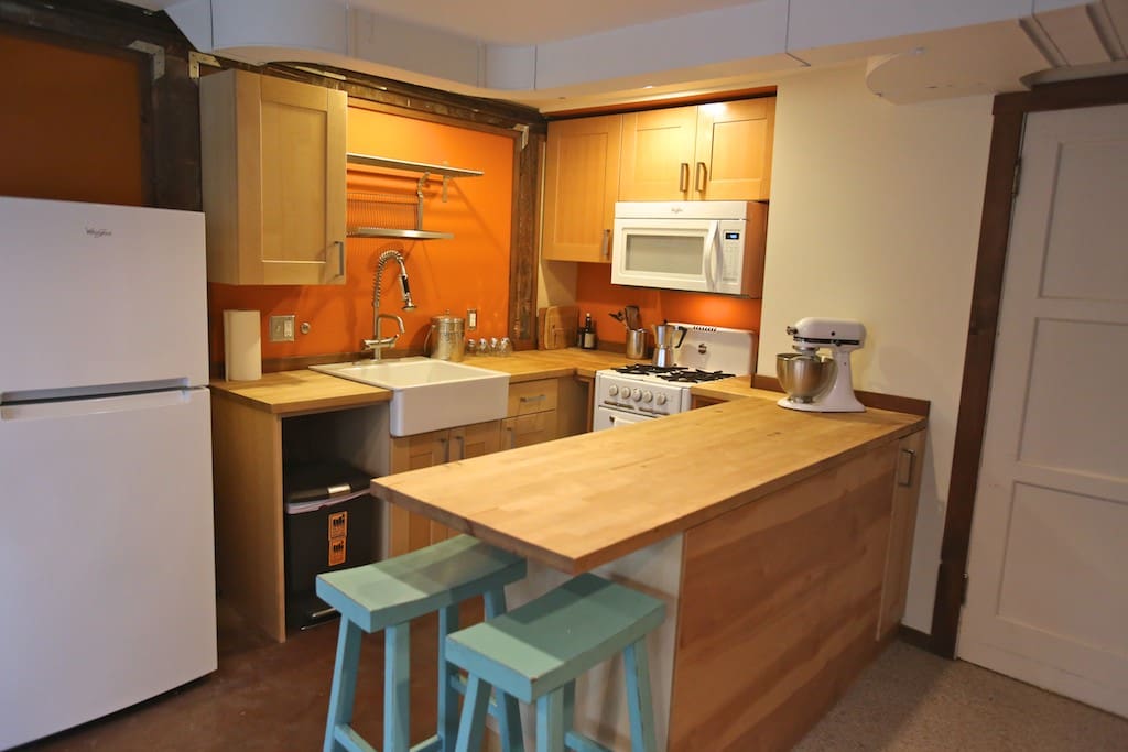 Kitchen with gas stove and microwave.