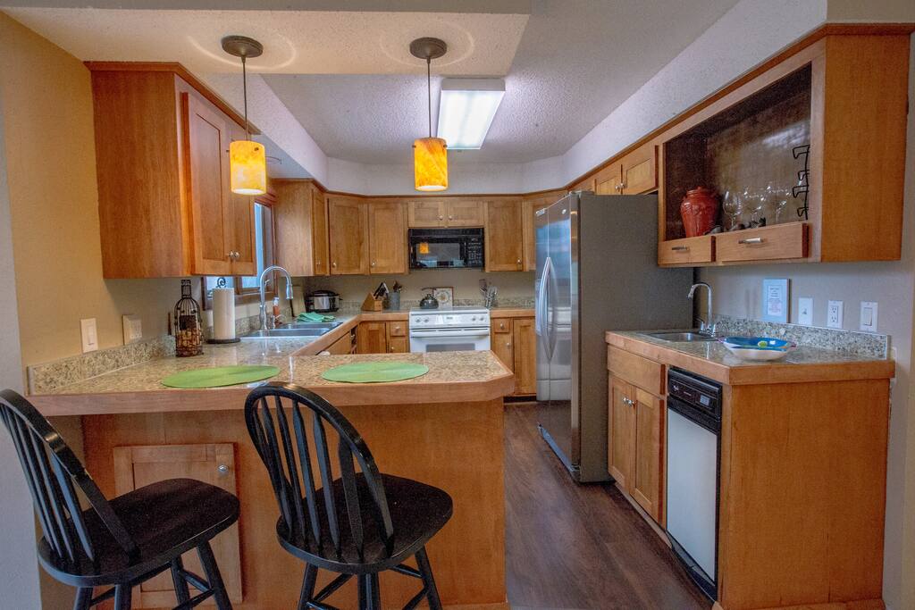 The fully equipped Kitchen opens to the Living Area. Dinnerware for 8 plus all the pots and pans you will need for your stay.