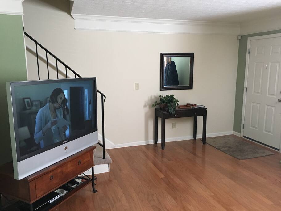 Beautiful hardwood floors on the first floor. The living room is right there when you open the door. A great TV equipped with lots of TV channels (most any sports, lots of movie channels and a PlayStation 3 equipped with Netflix). Steps to upstairs are also right off of the living room.