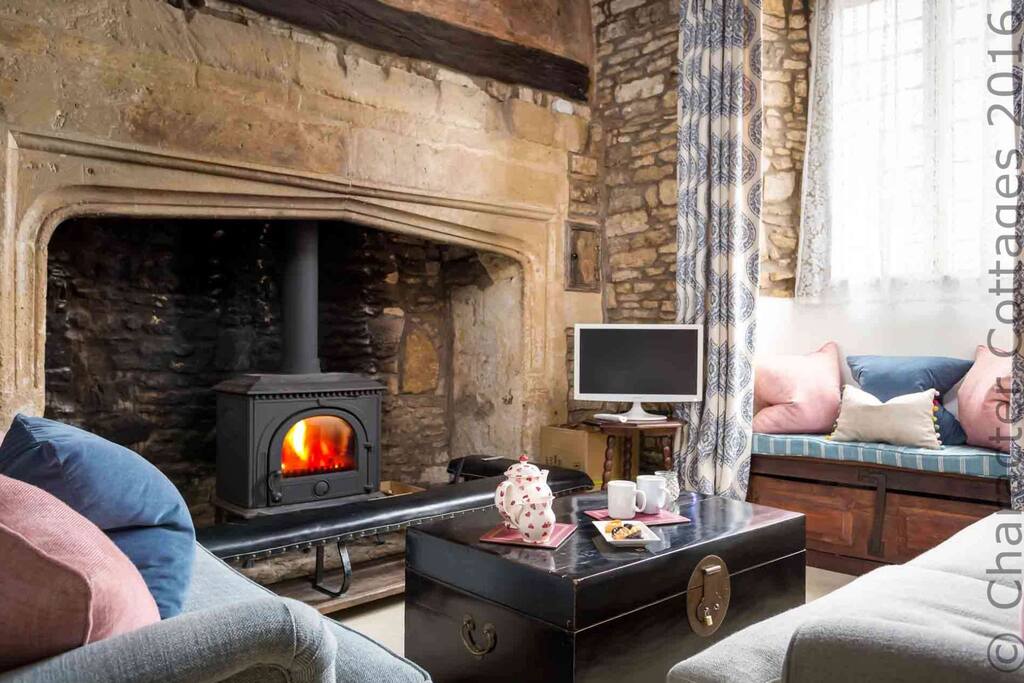 The historic fireplace contains a roaring log burner