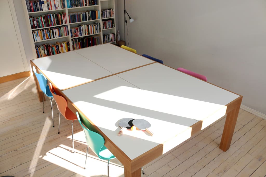 The dining table was custom built by a local designer and doubles as a competition-size ping pong table