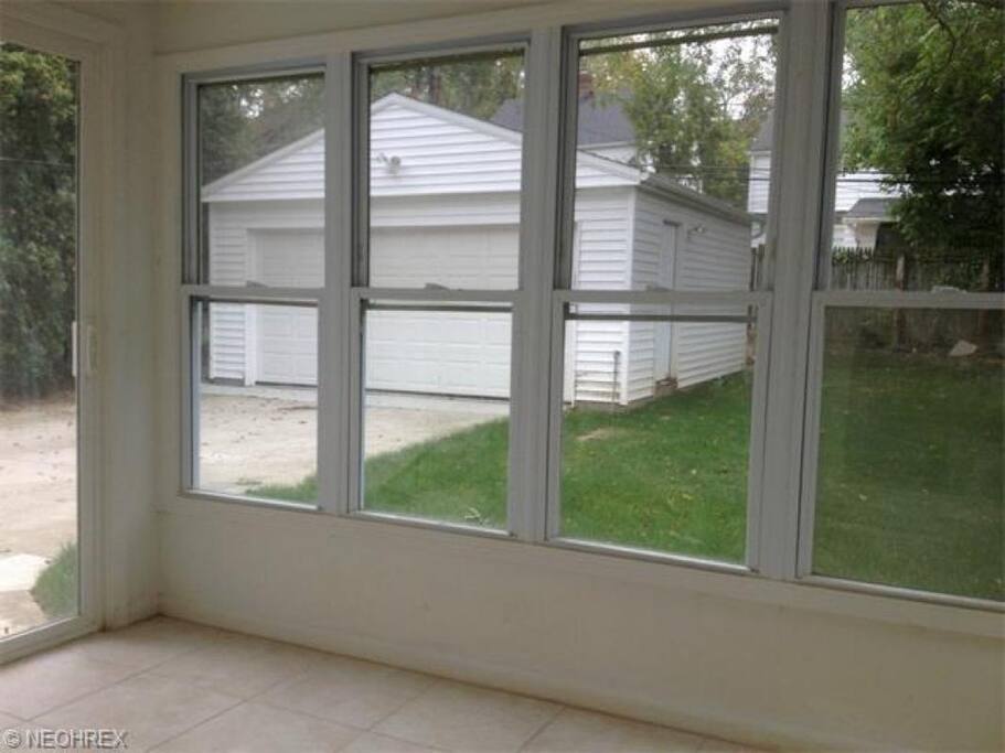 Back porch, backyard, and two-car garage.