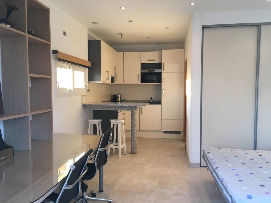 The Studio has a private and fully equipped kitchen, with a small dining table.