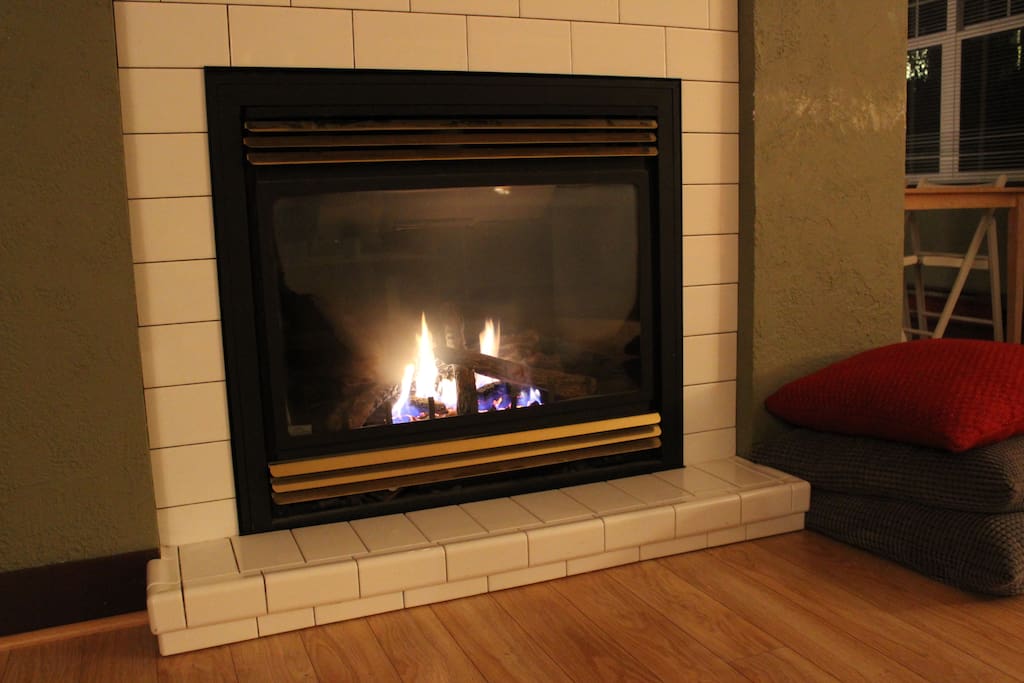 The living room features a large gas fireplace.