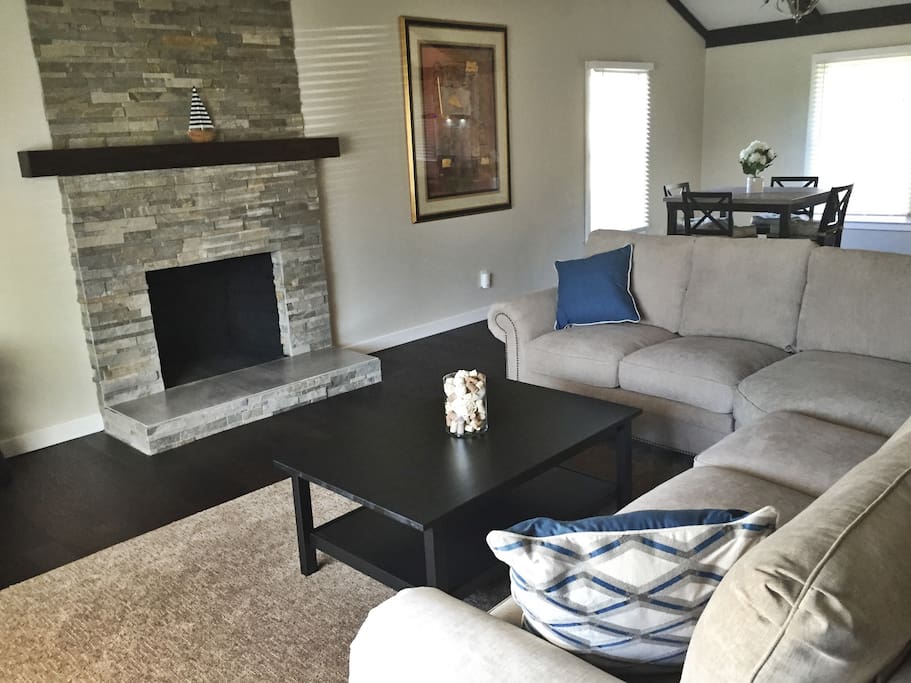 Custom built fireplace highlights the open living room space.