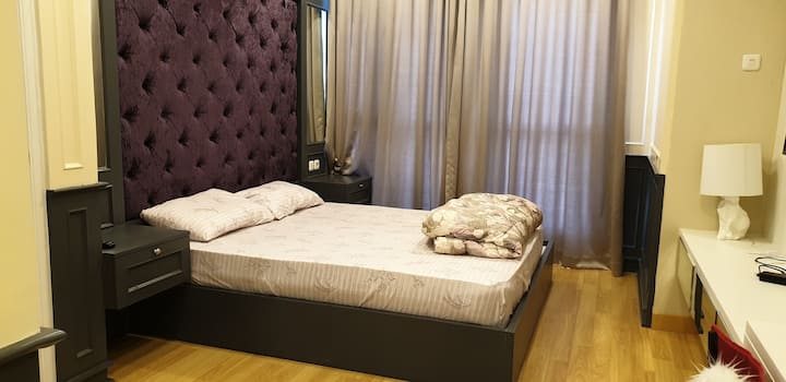 Queen size bed in master bedroom, with comfortable bedcover for your sweet dreams. 