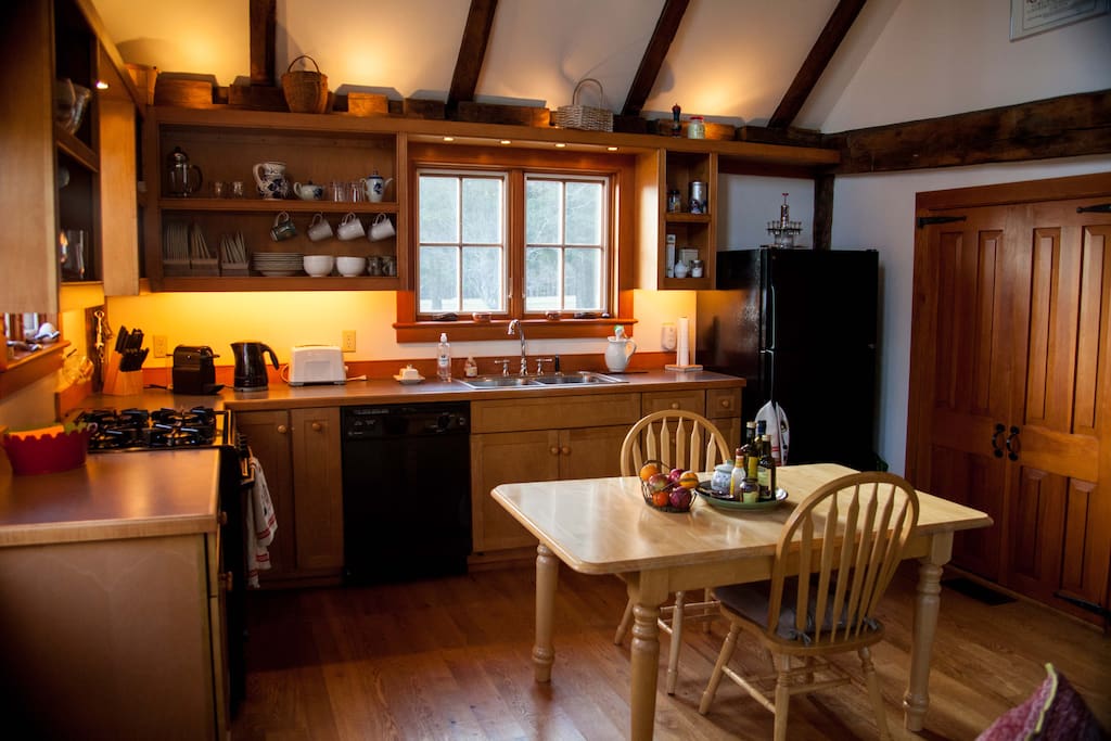 The expandable kitchen table can accommodate six for a meal. There are a gas range/oven for baking, a Nespresso coffee maker,( and press pot) toaster, and a microwave oven ( behind pantry doors). The kitchen is fully equipped with pots and pans, dishes, silver, glasses etc.