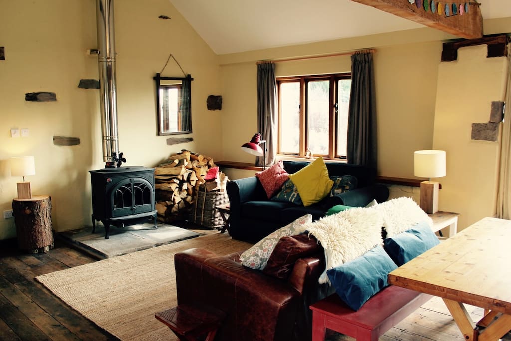 Rest in front of the log-burning stove in the warm, light, open plan living area.