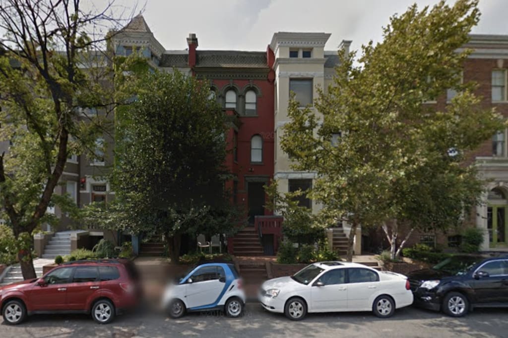 The apartment is in the maroon building on the top floor - you can see the street-facing balcony!