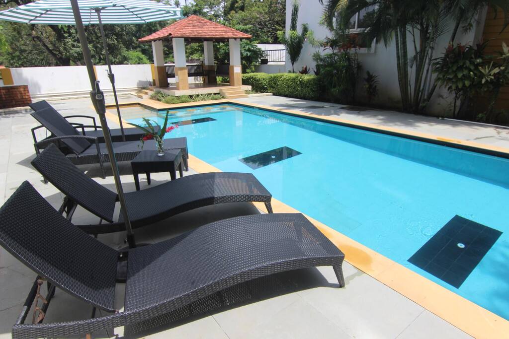 Swimming Pool Area with Sun beds