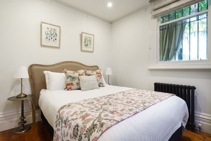 The second bedroom offers a very comfortable queen bed in a delightful botanical theme. 