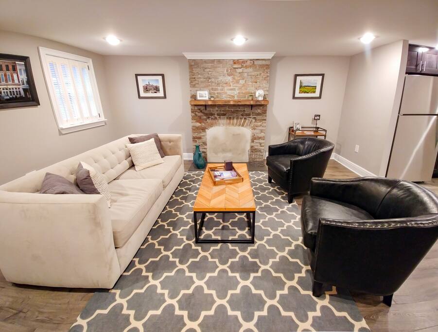 The main living area features an restored decorative fireplace and plenty of seating