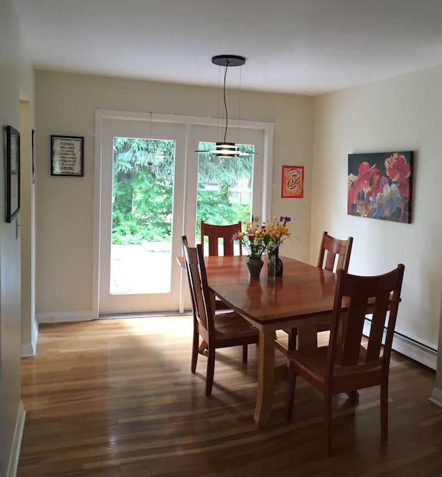 Dining area with large deck surrounded by large fenced backyard