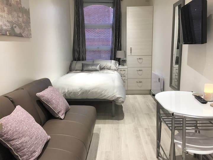 Comfy bed next to wardrobe and drawers
