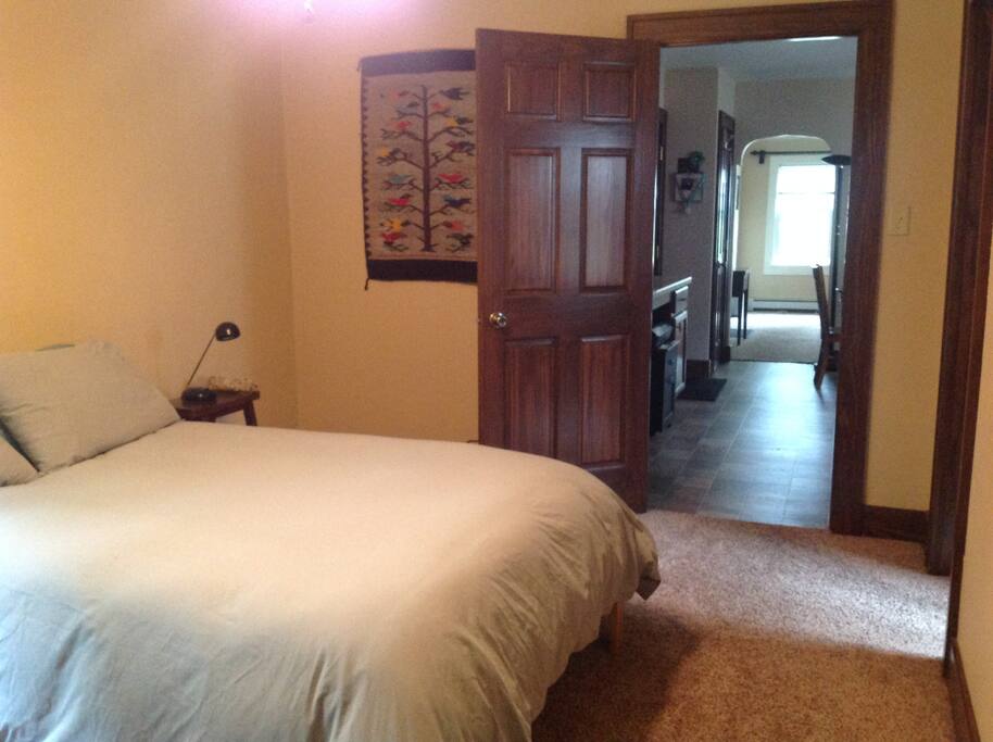 Bedroom from back corner, light on