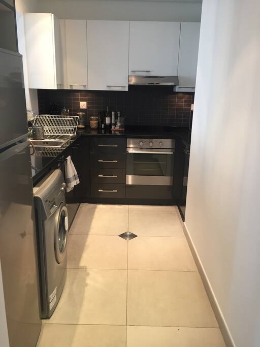kitchen with electric oven, microwave, and nespresso machine.