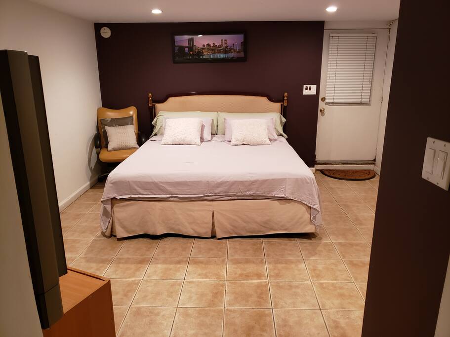 Bedroom with king size bed and door entrance