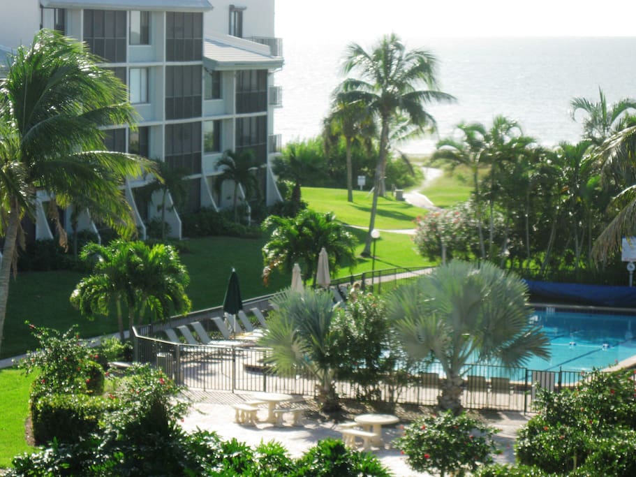 View from Screened Lanai toward the Pool & Beach. Stroll down for sun & a swim!