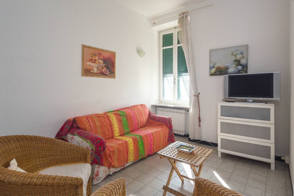 The living room is equipped with a TV