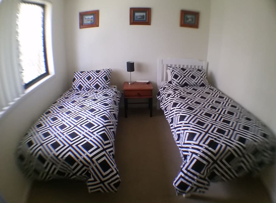 The room has two innerspring mattress single beds, that can be rearranged to meet your needs as a solo guest, twin or double.