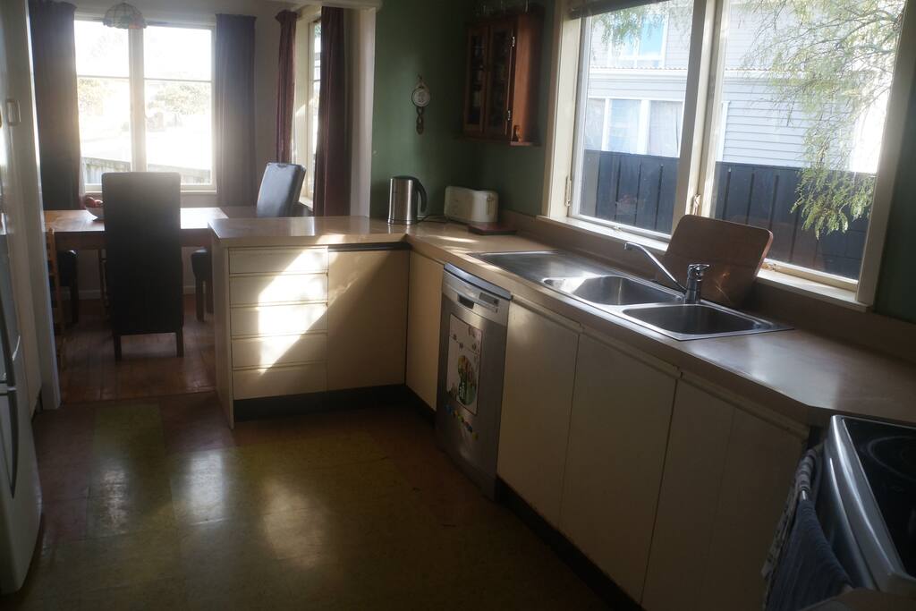 Kitchen with dishwasher, fridge/freezer, microwave and oven.